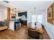 Open concept kitchen and dining area with modern cabinetry and a live edge table at 2883 16Th Ave N, St Petersburg, FL 33713