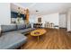 Open concept living area with hardwood floors, a sectional sofa, and access to the kitchen at 2883 16Th Ave N, St Petersburg, FL 33713