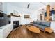 Living area with hardwood floors, a fireplace, and a comfortable sectional sofa at 2883 16Th Ave N, St Petersburg, FL 33713