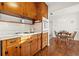 Kitchen with wood cabinets, tile floor and a view to the dining room at 3110 W Powhatan Ave, Tampa, FL 33614