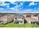 Backyard of a house with a screened patio, surrounded by other homes at 3278 Woodland Brook Way, Wesley Chapel, FL 33543