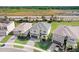 Three homes viewed from above showcasing similar architectural style at 3278 Woodland Brook Way, Wesley Chapel, FL 33543