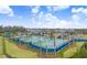 Community tennis courts and playground with surrounding landscape at 3278 Woodland Brook Way, Wesley Chapel, FL 33543