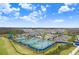 Community tennis courts and playground with surrounding landscape at 3278 Woodland Brook Way, Wesley Chapel, FL 33543