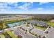 Aerial view showing clubhouse, tennis courts, and parking lot at 3278 Woodland Brook Way, Wesley Chapel, FL 33543