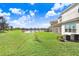 Spacious backyard with pond view and lush green grass at 3278 Woodland Brook Way, Wesley Chapel, FL 33543