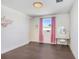 Charming bedroom with hardwood floors and pink accents at 3278 Woodland Brook Way, Wesley Chapel, FL 33543