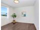 Spacious bedroom with dark hardwood floors and large window at 3278 Woodland Brook Way, Wesley Chapel, FL 33543
