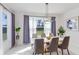 Bright dining room with a large table and gray chairs at 3278 Woodland Brook Way, Wesley Chapel, FL 33543