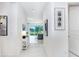 Bright and airy foyer with view to living room and large windows at 3278 Woodland Brook Way, Wesley Chapel, FL 33543
