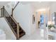 Bright entryway with modern staircase and tile flooring at 3278 Woodland Brook Way, Wesley Chapel, FL 33543