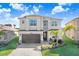 Two-story house with brown garage door, landscaping, and light-colored exterior at 3278 Woodland Brook Way, Wesley Chapel, FL 33543