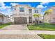 Two story house with a brown garage door and lush landscaping at 3278 Woodland Brook Way, Wesley Chapel, FL 33543