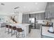 Modern kitchen with gray cabinets and a large island at 3278 Woodland Brook Way, Wesley Chapel, FL 33543