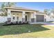 Brand new house with stone accents, a covered porch, and a two-car garage at 3326 W Heiter St, Tampa, FL 33607