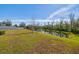 Landscaped backyard with pond and privacy fence at 35980 Morse Willow Ct, Zephyrhills, FL 33541