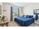 Bedroom with a blue comforter and large window at 35980 Morse Willow Ct, Zephyrhills, FL 33541