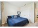 Spacious bedroom with a blue comforter and double doors at 35980 Morse Willow Ct, Zephyrhills, FL 33541