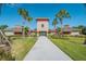 Community clubhouse with palm trees and walkway at 35980 Morse Willow Ct, Zephyrhills, FL 33541