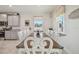 Farmhouse-style dining room with large table and seating for eight at 35980 Morse Willow Ct, Zephyrhills, FL 33541