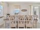 Farmhouse-style dining room with large table and seating for eight at 35980 Morse Willow Ct, Zephyrhills, FL 33541