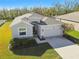One story home with attached garage and landscaping at 35980 Morse Willow Ct, Zephyrhills, FL 33541