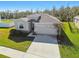 One-story house with attached garage and landscaping at 35980 Morse Willow Ct, Zephyrhills, FL 33541