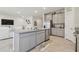 Modern kitchen with island, granite countertops, and stainless steel appliances at 35980 Morse Willow Ct, Zephyrhills, FL 33541