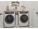 Laundry room with modern washer and dryer set at 35980 Morse Willow Ct, Zephyrhills, FL 33541