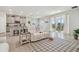 Living area with white reclining sofa and view to backyard at 35980 Morse Willow Ct, Zephyrhills, FL 33541