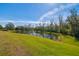 Serene pond with lush green landscaping at 35980 Morse Willow Ct, Zephyrhills, FL 33541