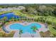 Kidney-shaped community pool with lounge chairs at 35980 Morse Willow Ct, Zephyrhills, FL 33541