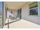 Relaxing screened porch with seating area and sliding glass door at 35980 Morse Willow Ct, Zephyrhills, FL 33541