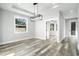 Spacious dining room with wood-look floors and modern light fixture at 405 W Louisiana Ave, Tampa, FL 33603