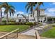 Landscaped backyard with lush greenery, a spacious patio, and canal views at 4687 Alisa Ne Cir, St Petersburg, FL 33703