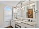 Double vanity bathroom with marble countertops and a large mirror at 4687 Alisa Ne Cir, St Petersburg, FL 33703
