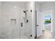 Bathroom with a walk-in shower, marble tile, and access to the pool at 4687 Alisa Ne Cir, St Petersburg, FL 33703