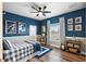 Blue-themed bedroom with a double bed, wood floors, and built-in shelving at 4687 Alisa Ne Cir, St Petersburg, FL 33703