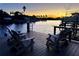 Relaxing waterfront dock with wooden chairs at sunset at 4687 Alisa Ne Cir, St Petersburg, FL 33703
