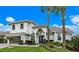 Two-story house with white exterior, gray garage door, and palm trees at 4687 Alisa Ne Cir, St Petersburg, FL 33703