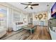 Bright living room features hardwood floors, a cozy seating area, and a fireplace at 4687 Alisa Ne Cir, St Petersburg, FL 33703