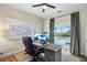 Home office with a large desk, pool view, and ample natural light at 4687 Alisa Ne Cir, St Petersburg, FL 33703