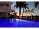 Inviting pool at dusk with palm trees and waterfront views at 4687 Alisa Ne Cir, St Petersburg, FL 33703