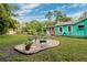 Charming backyard with stone patio and lush tropical landscaping at 5107 27Th S Ave, Gulfport, FL 33707