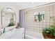Clean bathroom with a shower/tub combo, tile floors and a window at 5107 27Th S Ave, Gulfport, FL 33707