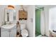 Small bathroom with gray vanity, walk-in shower, and wooden cabinet at 5107 27Th S Ave, Gulfport, FL 33707