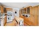 Open kitchen with wood cabinets, stainless steel appliances & kitchen island at 5107 27Th S Ave, Gulfport, FL 33707