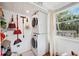 Bright laundry room with washer, dryer, and storage shelves at 5107 27Th S Ave, Gulfport, FL 33707