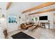 Cozy living room with exposed beams, leather couch and entryway at 5107 27Th S Ave, Gulfport, FL 33707