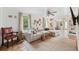Light-filled living area showcasing a comfortable sectional sofa and a charming, eclectic decor at 5107 27Th S Ave, Gulfport, FL 33707